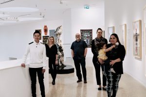 Organizers walk through and pose in the gallery of the Winnipeg Art Gallery-Qaumajuq. 